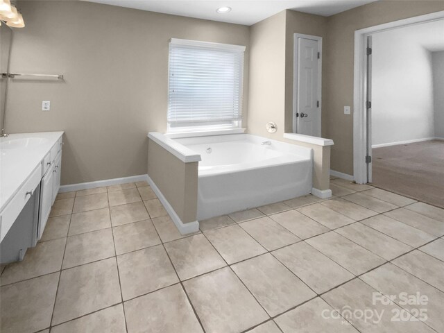 full bath featuring baseboards, vanity, a bath, and tile patterned floors