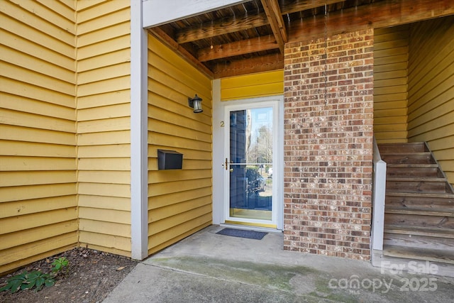 property entrance with brick siding