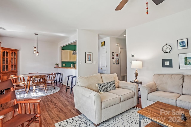 living room featuring ceiling fan, light wood-type flooring, and visible vents