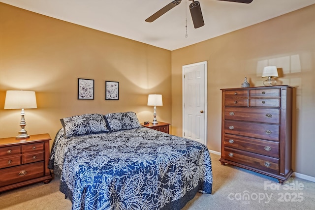 bedroom with light colored carpet, ceiling fan, and baseboards