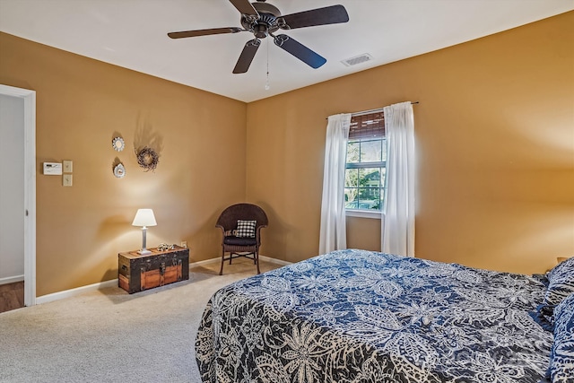 carpeted bedroom with baseboards, visible vents, and ceiling fan