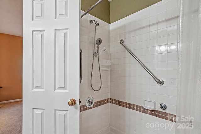 bathroom with a tile shower