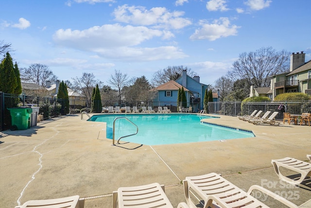 pool featuring a patio area and fence