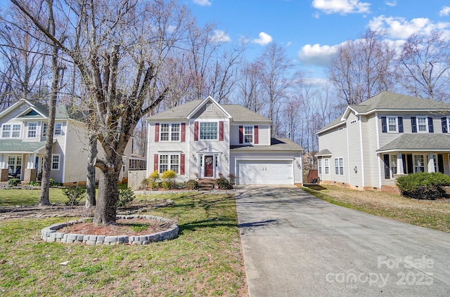 view of front of property with an attached garage, a front lawn, and concrete driveway