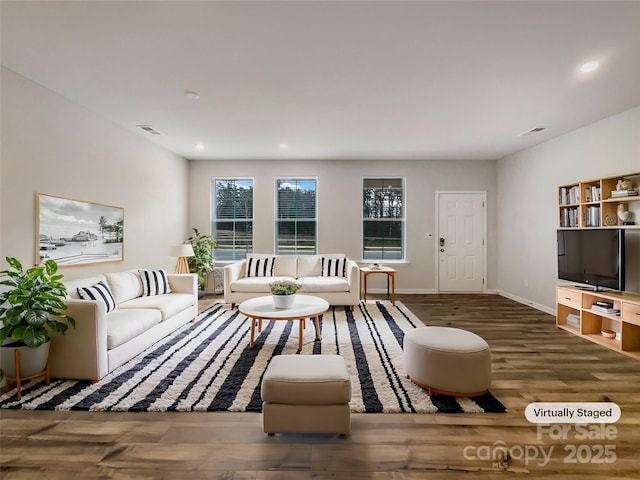 living area featuring recessed lighting, visible vents, baseboards, and wood finished floors