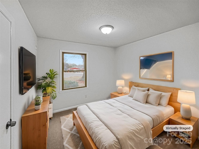 carpeted bedroom featuring a textured ceiling