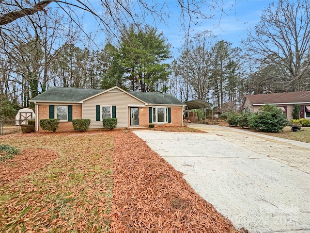 single story home with concrete driveway and brick siding