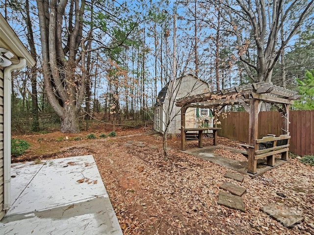 view of yard with a patio area, fence, and a pergola