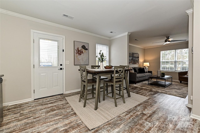 dining area featuring ceiling fan, baseboards, visible vents, and ornamental molding