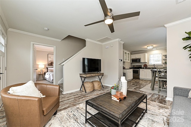 living area featuring light wood-style floors, stairway, crown molding, and baseboards