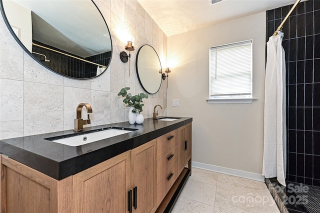 full bathroom with tile walls, tiled shower, and a sink