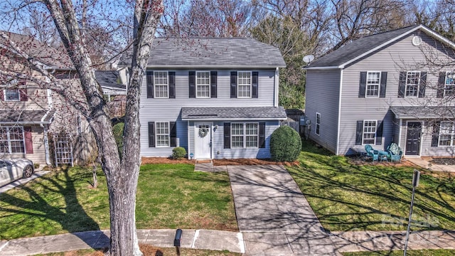 view of front of home featuring a shingled roof and a front yard