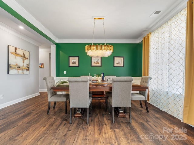 dining area with baseboards, visible vents, dark wood-style flooring, crown molding, and a chandelier