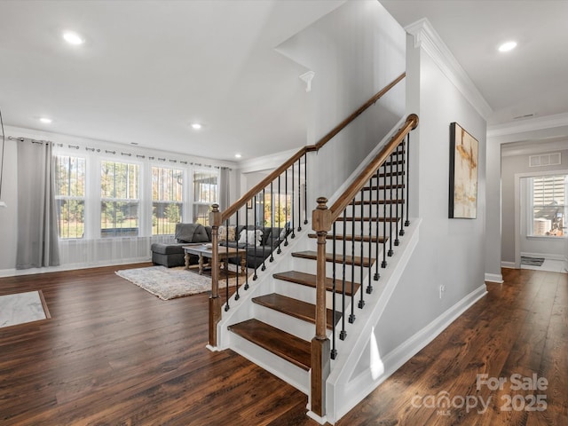 staircase featuring visible vents, wood finished floors, recessed lighting, crown molding, and baseboards