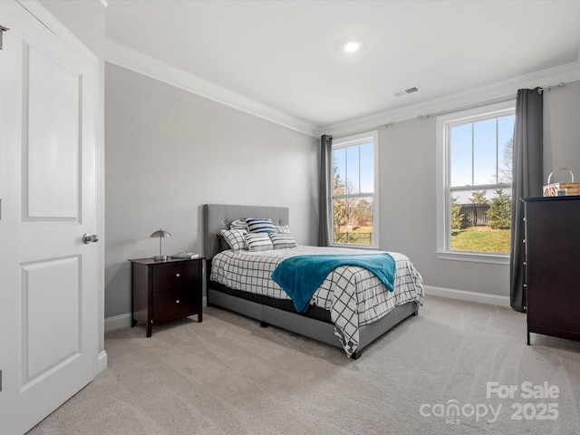 carpeted bedroom with visible vents, baseboards, and ornamental molding