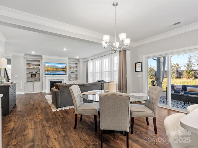 dining area with a wealth of natural light, visible vents, dark wood finished floors, and ornamental molding