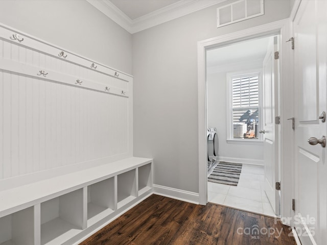 mudroom featuring visible vents, baseboards, crown molding, and dark wood-type flooring