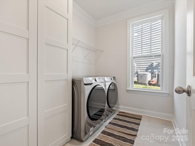 laundry room with light tile patterned floors, baseboards, laundry area, separate washer and dryer, and ornamental molding