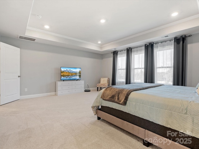 carpeted bedroom with visible vents, a raised ceiling, baseboards, and ornamental molding