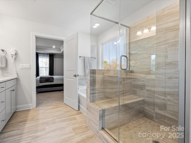 bathroom featuring a garden tub, vanity, ensuite bath, and a shower stall