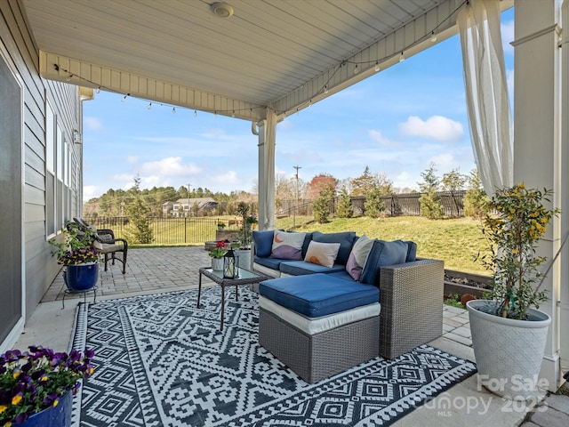 view of patio / terrace with an outdoor living space and a fenced backyard