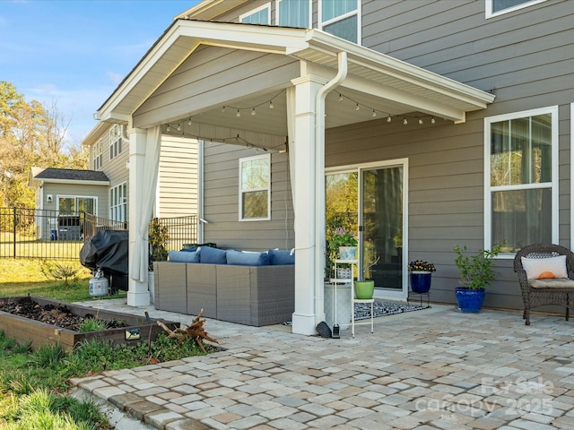 view of patio with area for grilling, outdoor lounge area, and fence