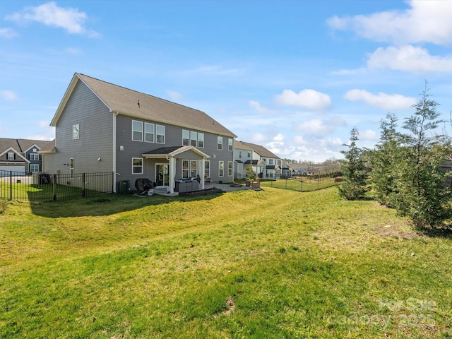 rear view of property with central air condition unit, a patio, a lawn, and a fenced backyard