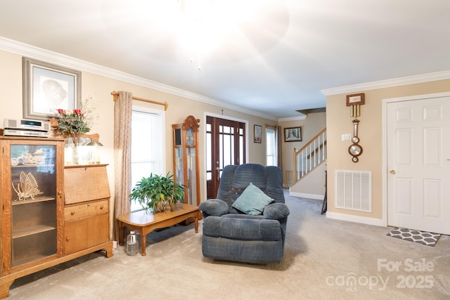 living area with visible vents, baseboards, stairs, carpet, and crown molding