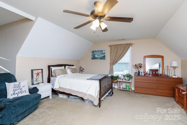 carpeted bedroom with lofted ceiling, visible vents, and ceiling fan