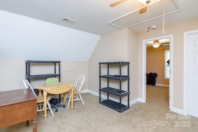 carpeted office space featuring attic access, lofted ceiling, visible vents, and baseboards