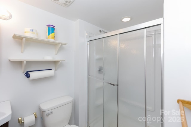 full bath with a stall shower, visible vents, and toilet