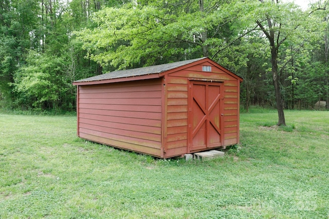 view of shed with a wooded view