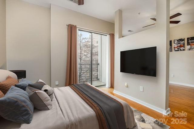 bedroom with visible vents, ceiling fan, baseboards, wood finished floors, and access to outside