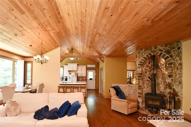 living area featuring dark wood-style floors, lofted ceiling, a wood stove, and wooden ceiling