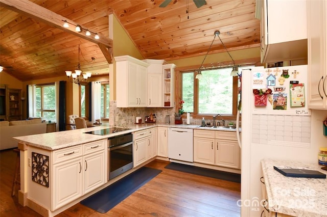 kitchen featuring white appliances, dark wood-style floors, wood ceiling, a peninsula, and a sink