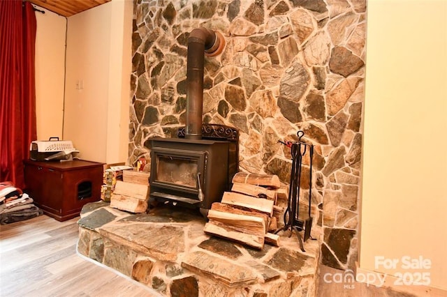 room details featuring a wood stove and wood finished floors