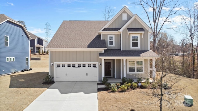 view of front facade featuring an attached garage, covered porch, concrete driveway, roof with shingles, and board and batten siding