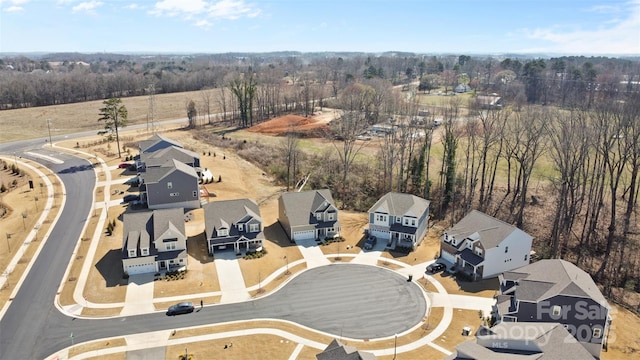 drone / aerial view with a forest view and a residential view