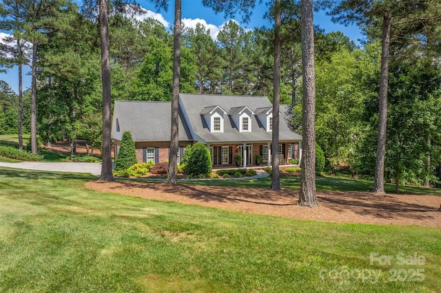 view of front of house with a front lawn and brick siding