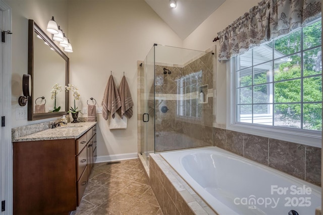 full bath with vanity, vaulted ceiling, a shower stall, a bath, and tile patterned floors