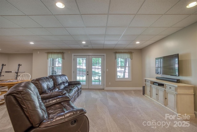 living room with french doors, recessed lighting, light colored carpet, a drop ceiling, and baseboards