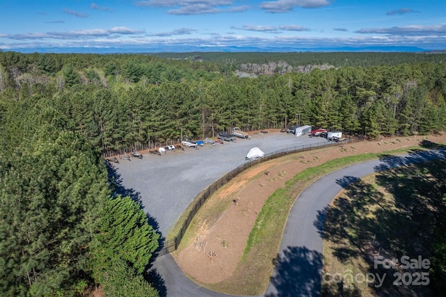 birds eye view of property featuring a view of trees