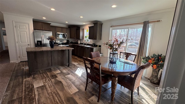 dining area with ornamental molding, dark wood-style flooring, and recessed lighting