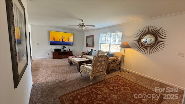 living area with baseboards, carpet floors, a ceiling fan, and crown molding