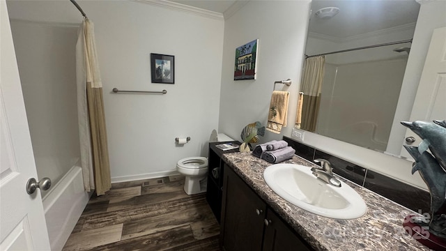 bathroom with baseboards, toilet, wood finished floors, crown molding, and vanity