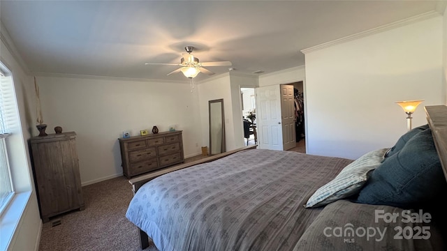 bedroom featuring a ceiling fan, baseboards, ornamental molding, and carpet flooring