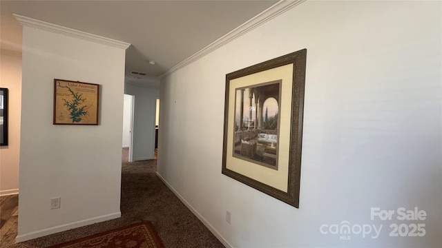 corridor with baseboards, dark carpet, visible vents, and crown molding