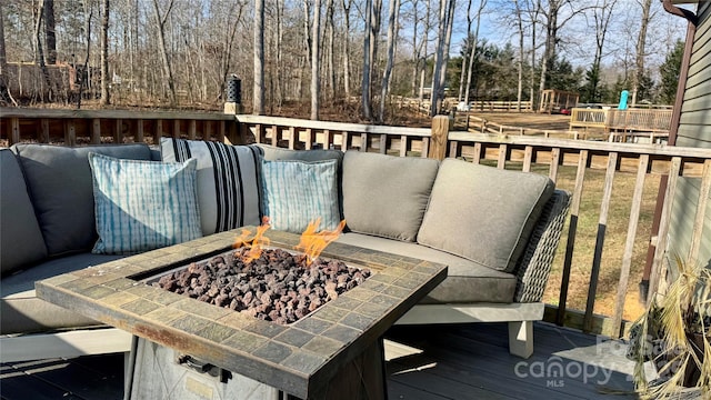 wooden deck with a fire pit