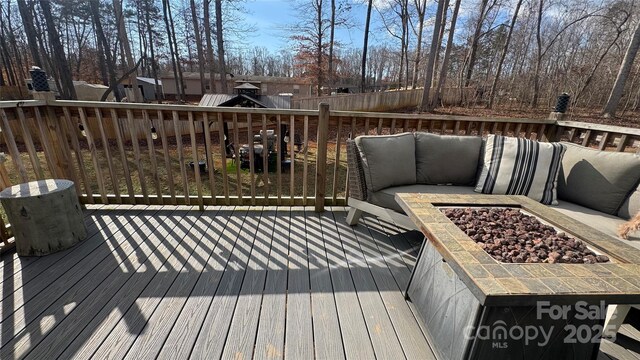 wooden deck with fence and a fire pit