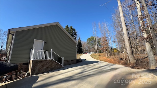 view of side of home with crawl space